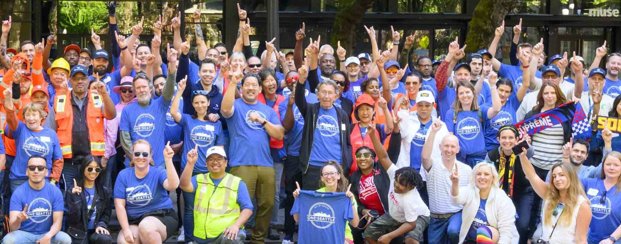 Mayor Harrell and volunteers wearing One Seattle shirt posing for photo in MLK Memorial Park 